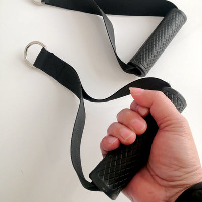 Black fitness resistance band with diamond patterned rubber-coated handle held in hand