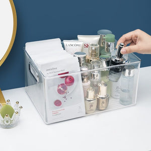 Clear plastic skin care product storage box organizer with multiple cosmetic bottles and face masks inside