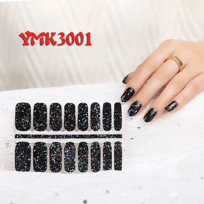 Black glitter nail wraps with sparkling effect, applied on fingernails and displayed on white surface