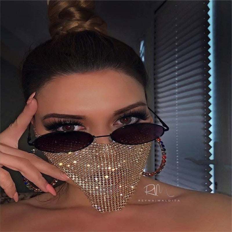 Woman wearing rhinestone metal jewelry face mask with sunglasses and hoop earrings