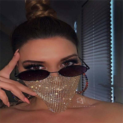 Woman wearing rhinestone metal jewelry face mask with sunglasses and hoop earrings