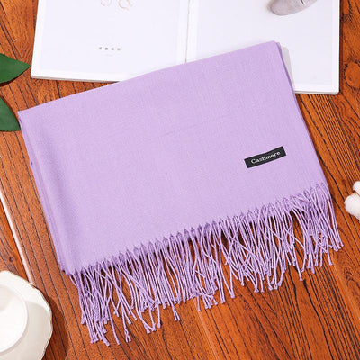 Soft lavender women scarf shawl with fringe detailing on wooden surface