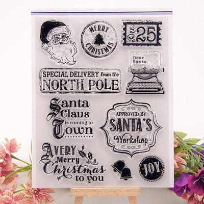 Transparent finished product stamp set with Christmas-themed designs including Santa, North Pole text, holiday messages, and festive icons in rectangle shape