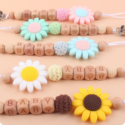 Colorful baby pacifier clips with silicone beech flower and wooden beads engraved with "BABY" text