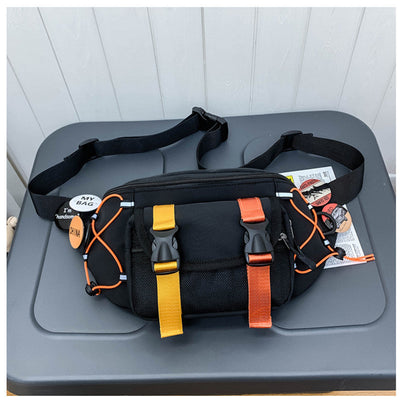 Black nylon ladies messenger bag with yellow and orange straps and badges, street fashion style