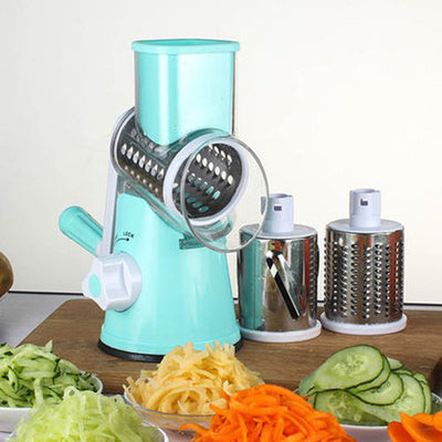 Manual kitchen accessory blue multifunctional round mandoline slicer with stainless steel blades and various vegetable cuts on a wooden board