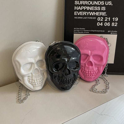 Women's fashion chain bags in skull design made of soft silicone in black, milky white, and rose red colors with single shoulder strap.